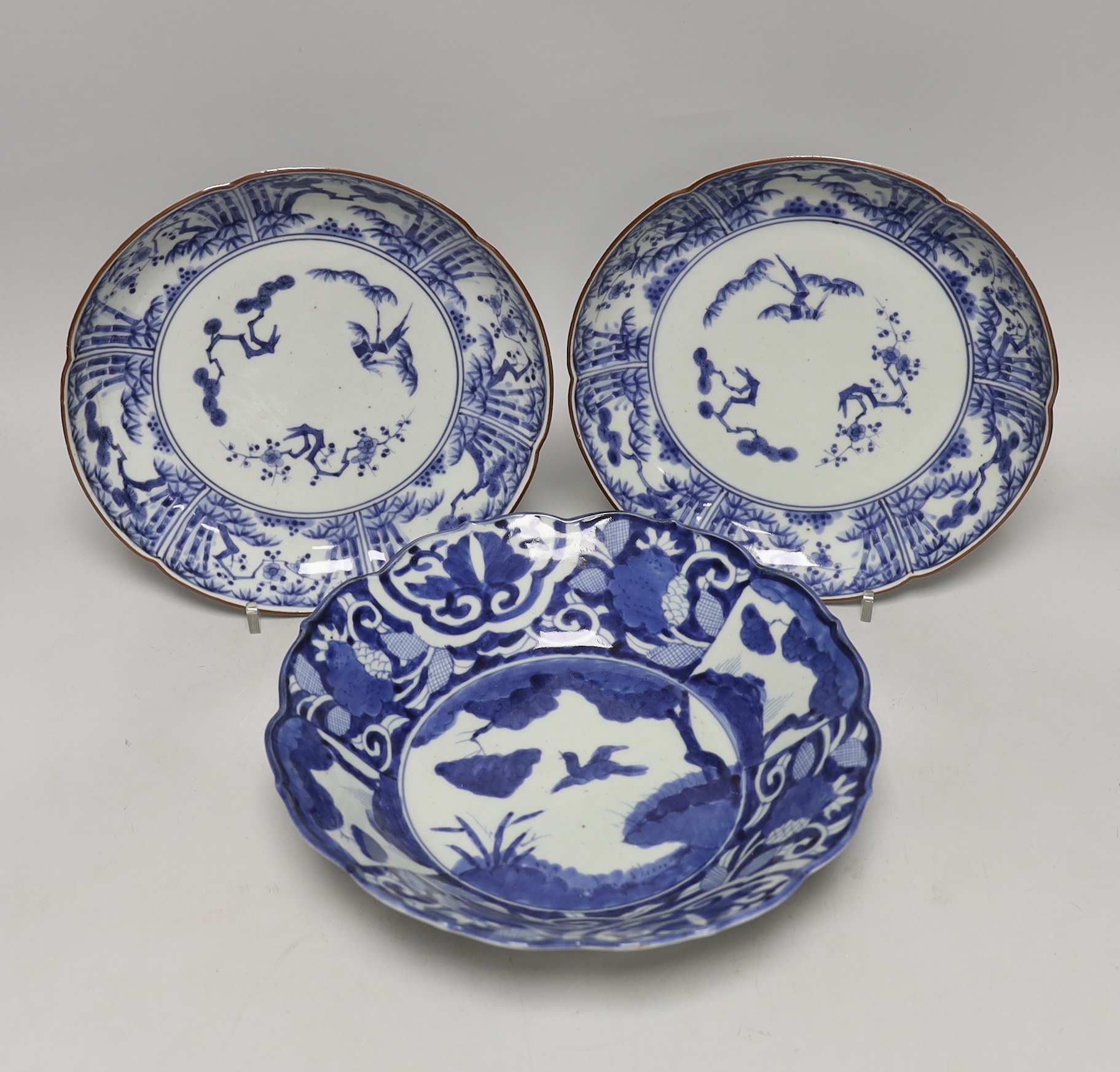 Three Japanese blue and white Arita dishes, largest 25cm